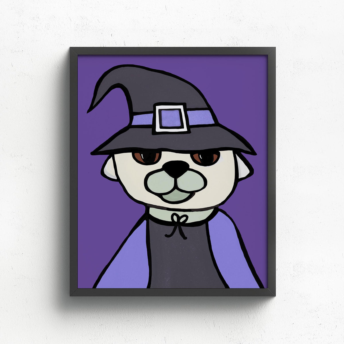 Pug Witch art print shown in a black frame on white wall. The art features a cream and gray pug dog in a black witch hat with purple band and a black dress with purple cape.