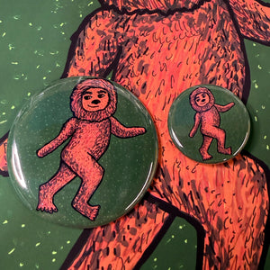 comparison view of 1.25 and 2.25 inch sizes of Big Foot button shown on top of a Big Foot print