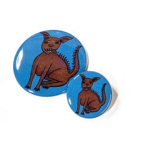 another view of the two sizes of chupacabra buttons