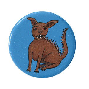 round blue button with chupacabra - hand drawn mythical creature with sharp teeth and spikes along his back
