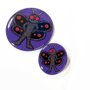 another view of the two sizes of mothman pins and magnets