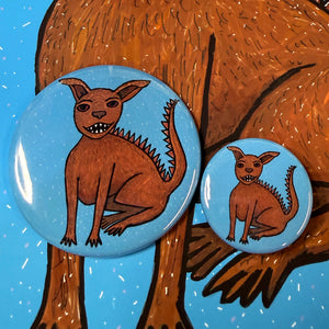 side by side view of chupacabra buttons - 1.25 inch and 2.25 inch