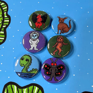 cryptid button set on blue background