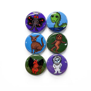 set of 6 round buttons - each with a different cryptid - Mothman, Loch Ness Monster, Chupacabra, Bigfoot, Jersey Devil and Yeti