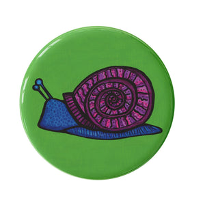 round green button with blue snail with purple spiral shell