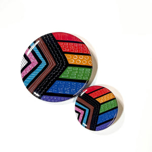 side by side view of 2.25 inch and 1.25 inch pride flag buttons