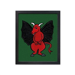 Jersey Devil art print in black frame - the devil has a red body with scales, white horns and black wings on a green background