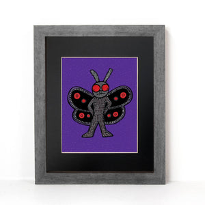 Mothman art print shown in a gray farme with black mat on a white wall