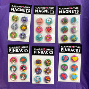 sample packaging of magnet and pin sets - black label with buttons on white board